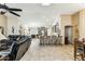 Open-concept living room with tile flooring, high ceilings, and seamless flow to kitchen at 10282 E Trailhead Ct, Gold Canyon, AZ 85118