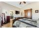 Comfortable primary bedroom with a ceiling fan, tile floors, and adjacent bathroom at 10282 E Trailhead Ct, Gold Canyon, AZ 85118