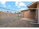 Backyard with gravel, chain link fence, and gate at 10572 W Echo Ln, Peoria, AZ 85345