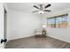 Bedroom with ceiling fan, light gray vinyl flooring, and window coverings at 10572 W Echo Ln, Peoria, AZ 85345