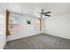 Bedroom with ceiling fan, gray carpet, and neutral-colored walls at 10572 W Echo Ln, Peoria, AZ 85345
