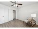 Bedroom with ceiling fan, light gray vinyl flooring, and closet at 10572 W Echo Ln, Peoria, AZ 85345