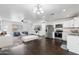 Open concept kitchen boasts modern appliances and dark hardwood floors at 10572 W Echo Ln, Peoria, AZ 85345