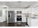 Modern kitchen with stainless steel appliances and white cabinets at 10572 W Echo Ln, Peoria, AZ 85345