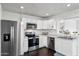 Modern kitchen featuring stainless steel appliances and white cabinets at 10572 W Echo Ln, Peoria, AZ 85345