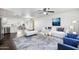 Bright living room features stylish furniture and flows into the kitchen at 10572 W Echo Ln, Peoria, AZ 85345
