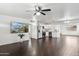 Open concept living room with kitchen and dark hardwood floors at 10572 W Echo Ln, Peoria, AZ 85345