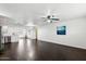Bright living room with dark hardwood floors and open floor plan at 10572 W Echo Ln, Peoria, AZ 85345