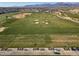 Aerial view of golf course with sand traps and distant mountains at 11444 N Northfield St, Surprise, AZ 85388