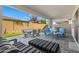 Spacious backyard patio with seating area, artificial turf, and built-in grill at 11444 N Northfield St, Surprise, AZ 85388