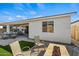 Inviting backyard with fire pit, patio, and artificial turf at 11444 N Northfield St, Surprise, AZ 85388