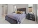 Bright bedroom with a queen bed, nightstand, and ensuite bathroom at 11444 N Northfield St, Surprise, AZ 85388