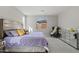 Main bedroom with large bed, chair, and mirrored dresser at 11444 N Northfield St, Surprise, AZ 85388