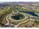 Aerial view of community landscape, roads, and water features with mountains in background at 11444 N Northfield St, Surprise, AZ 85388