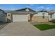 One-story home with stone accents and a two-car garage at 11444 N Northfield St, Surprise, AZ 85388