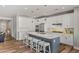 Modern kitchen with white cabinets, large island, and stainless steel appliances at 11444 N Northfield St, Surprise, AZ 85388
