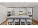 Modern kitchen with gray island and white cabinets, open to the living room at 11444 N Northfield St, Surprise, AZ 85388