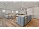 Modern kitchen with gray island, white cabinets, and stainless steel appliances at 11444 N Northfield St, Surprise, AZ 85388