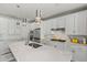 Modern kitchen with white cabinets, large island, and stainless steel appliances at 11444 N Northfield St, Surprise, AZ 85388