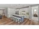 Modern kitchen with white cabinets, large island, and stainless steel appliances at 11444 N Northfield St, Surprise, AZ 85388