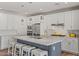 Modern kitchen with white cabinets, large island, and stainless steel appliances at 11444 N Northfield St, Surprise, AZ 85388