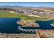 Aerial view of a lake with a waterfall and surrounding landscape at 11444 N Northfield St, Surprise, AZ 85388