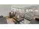 Living room with gray sofas and striped armchairs, open to the kitchen at 11444 N Northfield St, Surprise, AZ 85388