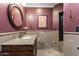 Elegant bathroom featuring a granite countertop, a round mirror, and a mosaic-tiled shower at 1449 E Mulberry St, Phoenix, AZ 85014