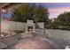Inviting backyard with a brick fireplace and seating area at 15406 W Pinchot Ct, Goodyear, AZ 85395