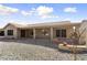 Spacious backyard with covered patio, brick accents and decorative metal artwork at 15406 W Pinchot Ct, Goodyear, AZ 85395