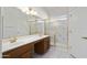 Bathroom featuring double sinks, a vanity area, and a shower with glass doors at 15406 W Pinchot Ct, Goodyear, AZ 85395