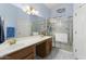 Bright bathroom features double sinks, a large mirror, and a glass-enclosed shower at 15406 W Pinchot Ct, Goodyear, AZ 85395