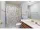Traditional bathroom with floral shower curtain and vanity sink at 15406 W Pinchot Ct, Goodyear, AZ 85395