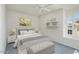 Bright bedroom featuring a queen-size bed, decorative shelves and stylish decor at 15406 W Pinchot Ct, Goodyear, AZ 85395