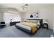 Serene bedroom with a blue bed, a ceiling fan, soft lighting, and a spacious layout at 15406 W Pinchot Ct, Goodyear, AZ 85395