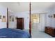 Spacious primary bedroom features sliding glass doors and a four-poster bed at 15406 W Pinchot Ct, Goodyear, AZ 85395
