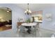 Elegant dining room with a modern round table and chandelier at 15406 W Pinchot Ct, Goodyear, AZ 85395