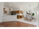 Open-concept kitchen featuring wood cabinets, stainless steel appliances, and a breakfast area with a modern dining set at 15406 W Pinchot Ct, Goodyear, AZ 85395