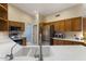 Well-equipped kitchen featuring stainless steel appliances, quartz countertop, and wood cabinetry at 15406 W Pinchot Ct, Goodyear, AZ 85395