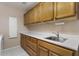 Well-lit laundry room featuring ample cabinet space and a sink at 15406 W Pinchot Ct, Goodyear, AZ 85395