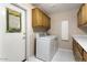 Functional laundry room with white appliances and ample cabinet space at 15406 W Pinchot Ct, Goodyear, AZ 85395