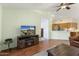 Living area with hardwood floors, ceiling fan, and kitchen access at 15406 W Pinchot Ct, Goodyear, AZ 85395