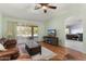 Comfortable living room with sliding glass doors, ceiling fan, and hardwood floors at 15406 W Pinchot Ct, Goodyear, AZ 85395