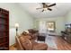 Inviting living room with hardwood floors, a ceiling fan, and sliding glass doors at 15406 W Pinchot Ct, Goodyear, AZ 85395