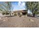 Landscaped backyard with gravel and a covered patio at 16203 W Starry Sky Dr, Surprise, AZ 85374