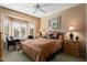 Main bedroom with large bed, ceiling fan, and window seating at 16203 W Starry Sky Dr, Surprise, AZ 85374