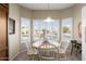 Bright breakfast nook with white table and chairs, offering a view at 16203 W Starry Sky Dr, Surprise, AZ 85374