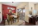 Charming dining room with a wood table and red accent wall at 16203 W Starry Sky Dr, Surprise, AZ 85374