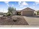 House exterior with gravel landscaping and a garage at 16203 W Starry Sky Dr, Surprise, AZ 85374