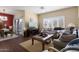 Open living area with a sofa, TV, and access to a patio at 16203 W Starry Sky Dr, Surprise, AZ 85374